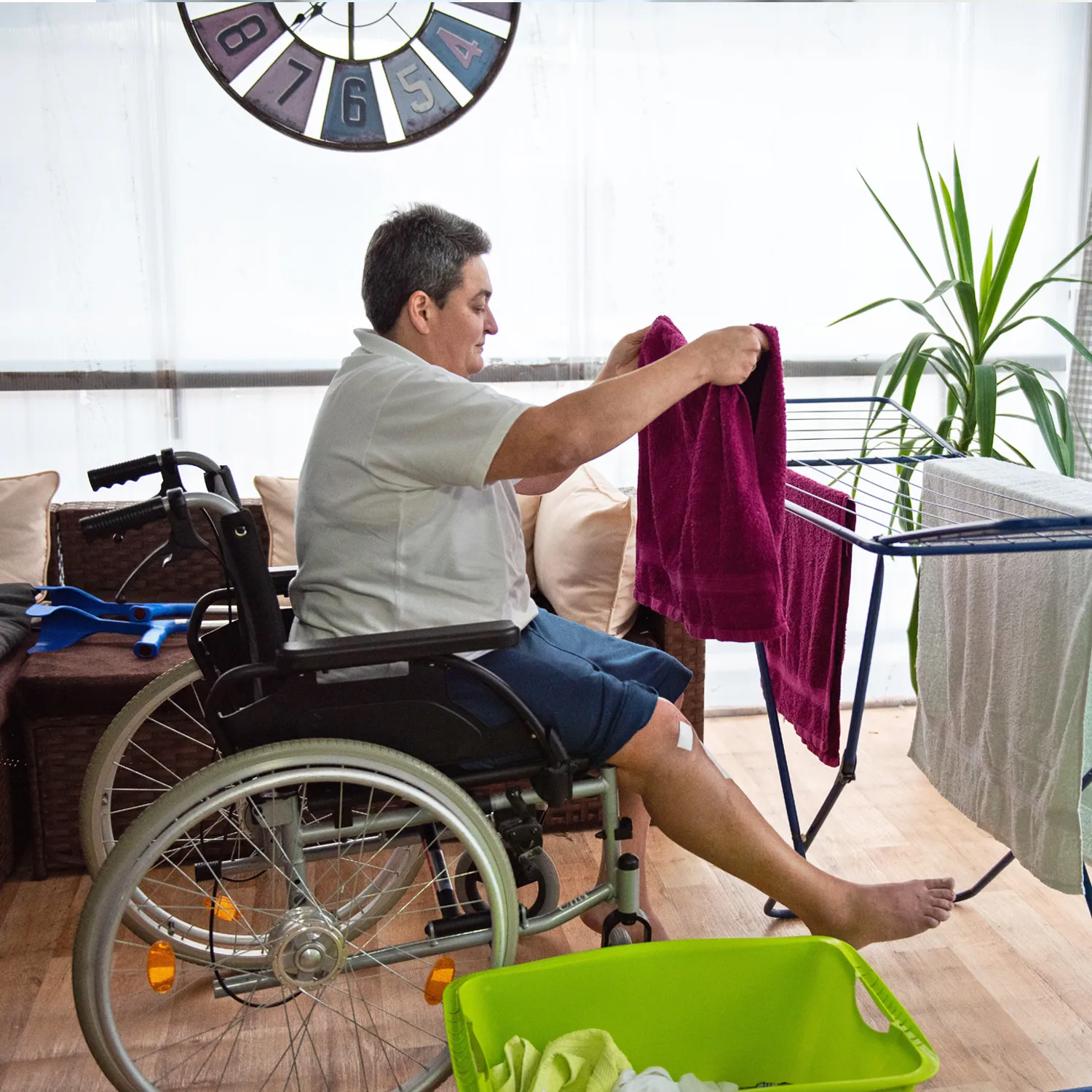 NDIS Provider Logan Central 1 Participant in a wheelchair hanging laundry at home